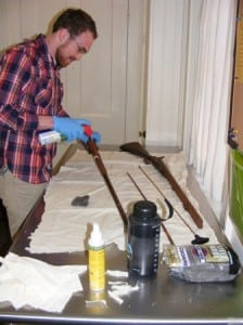 Dennis Shay, Fairfield Heritage Association intern, cleans a historic firearm. collection